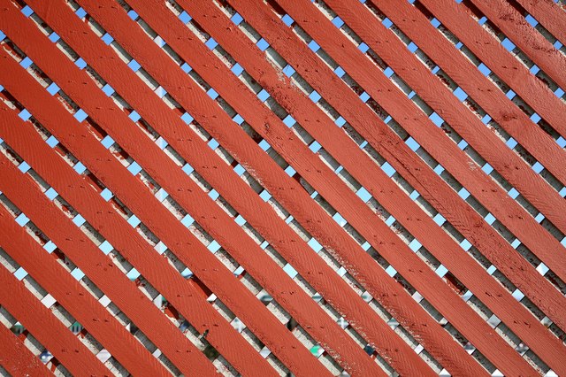 Pattern of wooden slats in chainlink fence