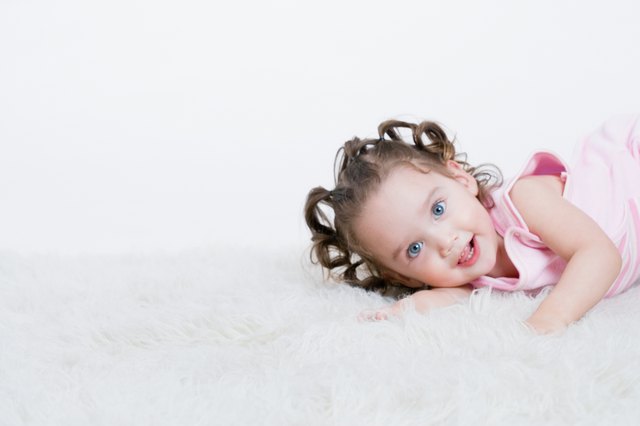 Studio shot of toddler on plush rug