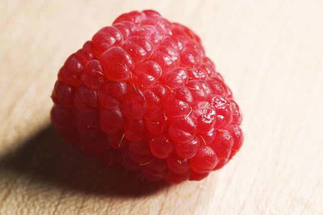 Macro of raspberry on wood cutting-board