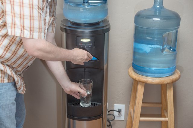 How to Change a 5-Gallon Water Cooler Bottle | Hunker How To Put 5 Gallon Water On Dispenser Without Spilling