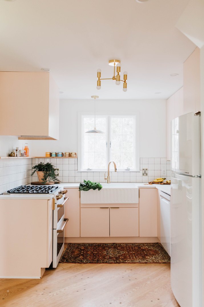 kitchen with pink cabinets and white walls