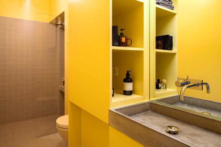 yellow bathroom with concrete sink