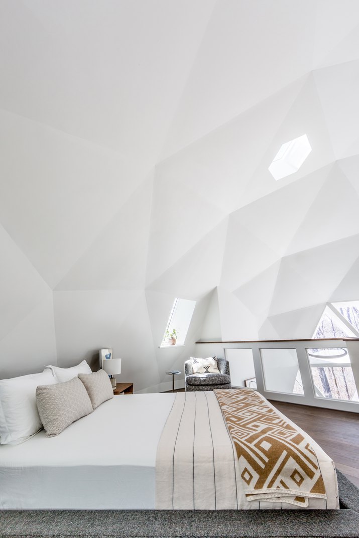lofted white bedroom in dome house