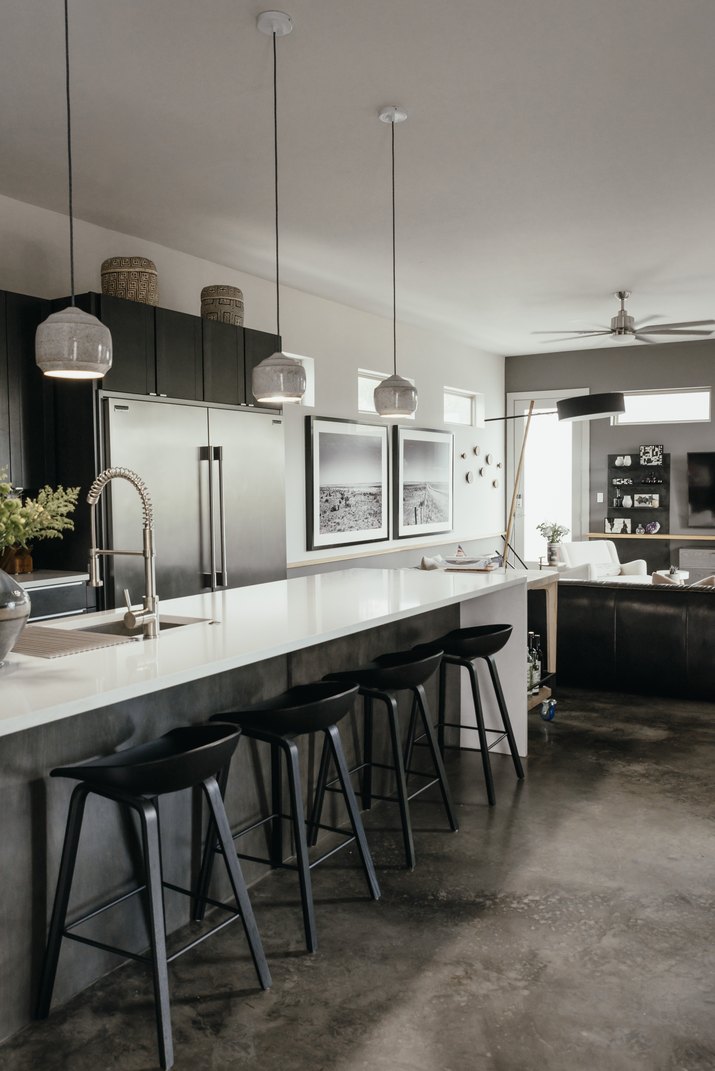 gray kitchen with concrete floor and bar seating