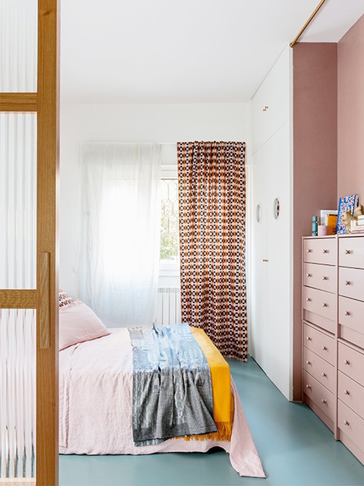 bedroom with pink walls and blue floors