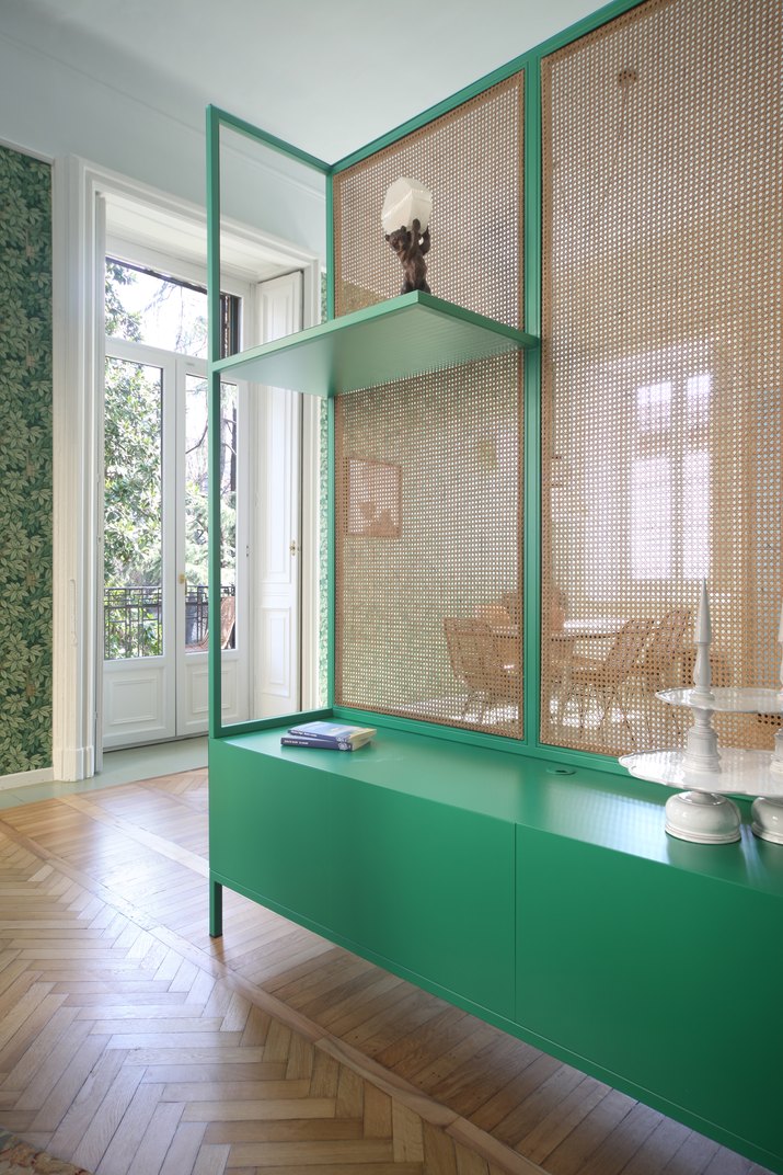 cane cabinet with green shelves