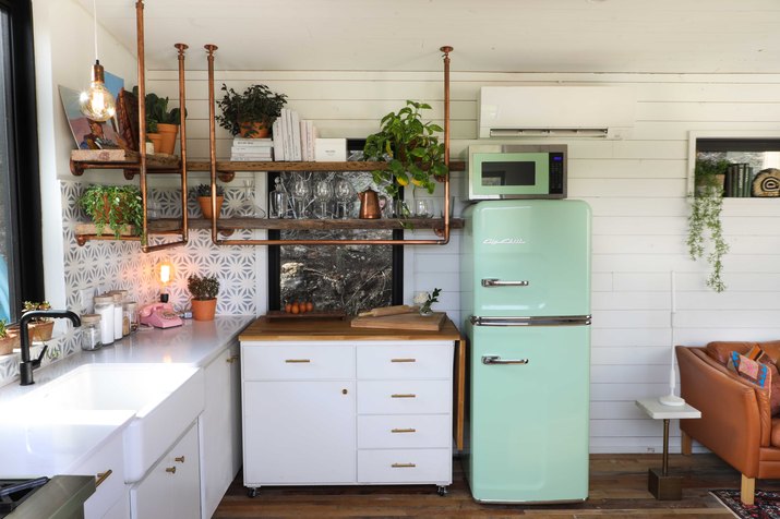 small white kitchen with copper accents