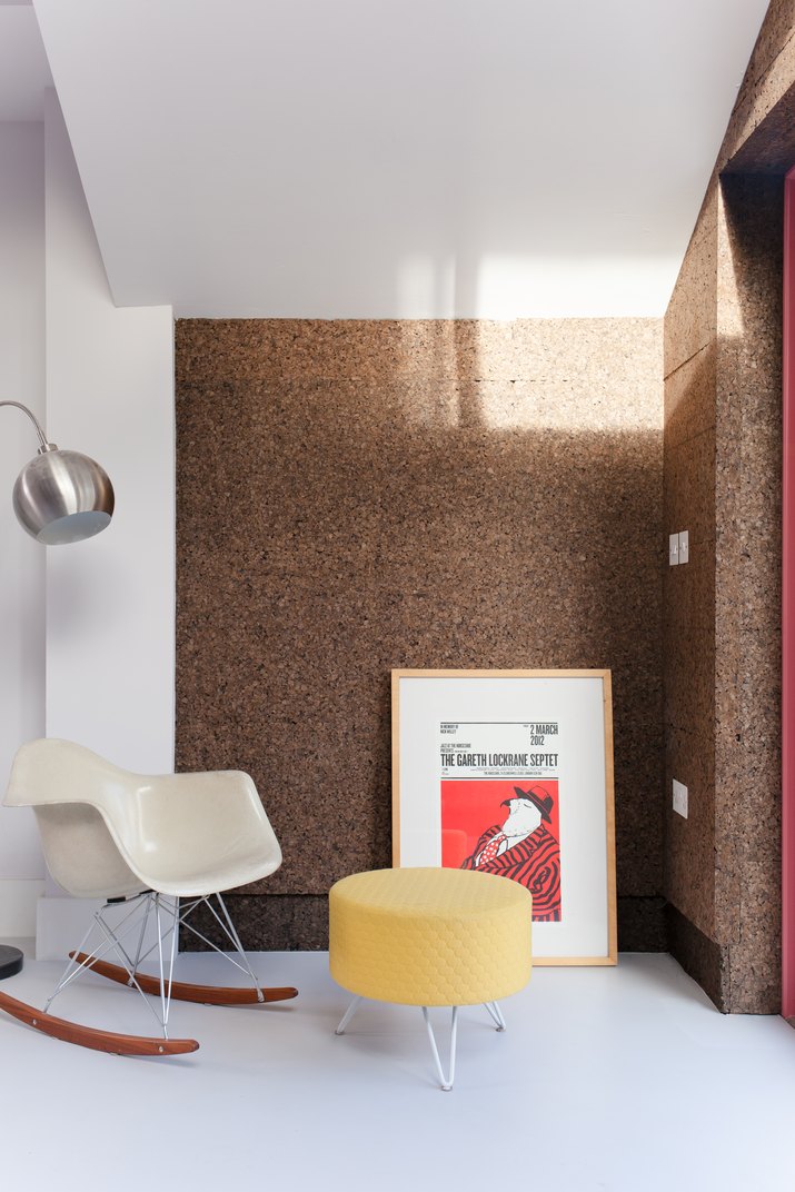 midcentury living room with cork walls and eames chair