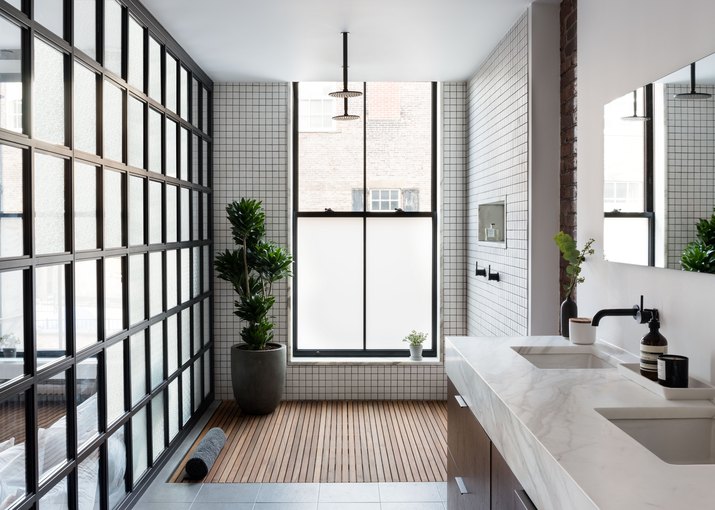 bathroom with open shower and tiled walls