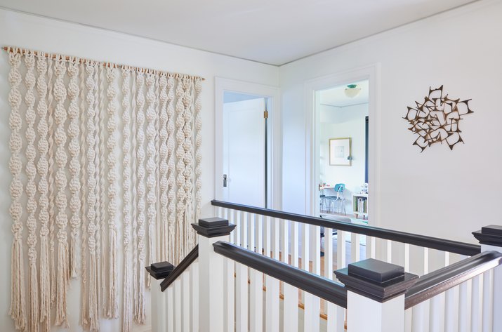 staircase with macrame wall hanging