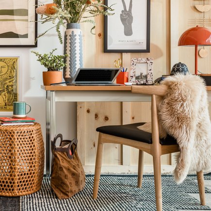 Bohemian Designed working desk with computer & plants & small side table with coffee